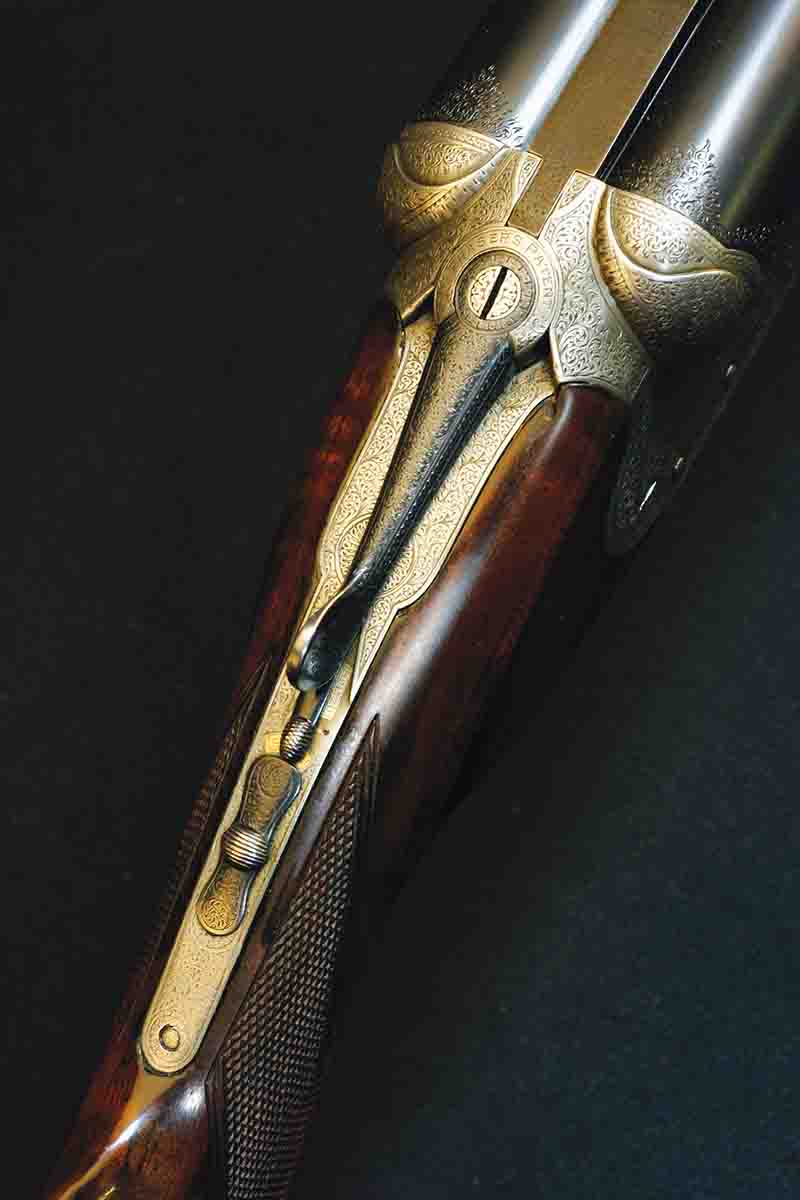 On this Daniel Fraser double rifle, engraving serves several purposes. It denotes “safe” and indicates if the stalking safety is “bolted.” It lists the relevant Fraser patent with tasteful scroll demurely framing this essential information.